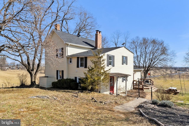 view of side of property with a chimney