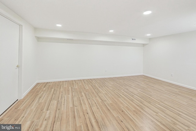 finished basement with baseboards, light wood finished floors, and recessed lighting