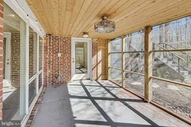 unfurnished sunroom featuring wooden ceiling