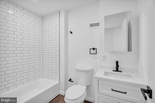 bathroom featuring toilet, shower / bath combination, wood finished floors, visible vents, and vanity