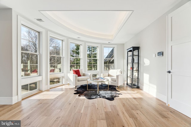 sunroom featuring a tray ceiling