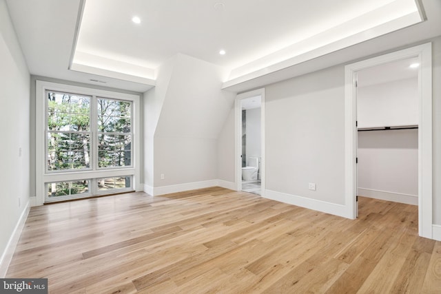 interior space featuring light wood-type flooring, baseboards, and recessed lighting