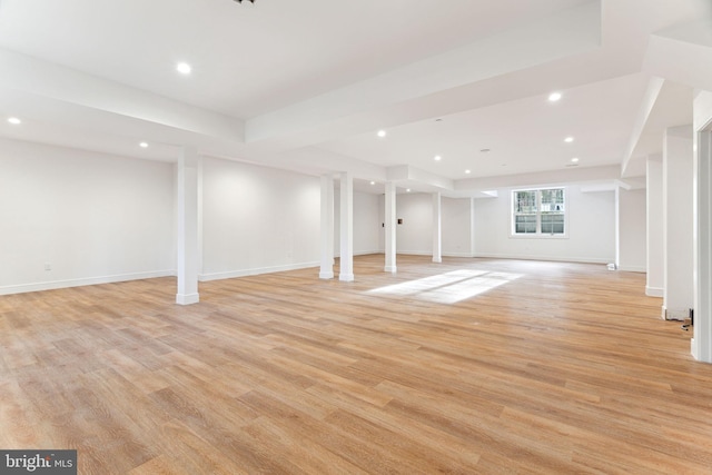 basement featuring light wood-style floors, baseboards, and recessed lighting