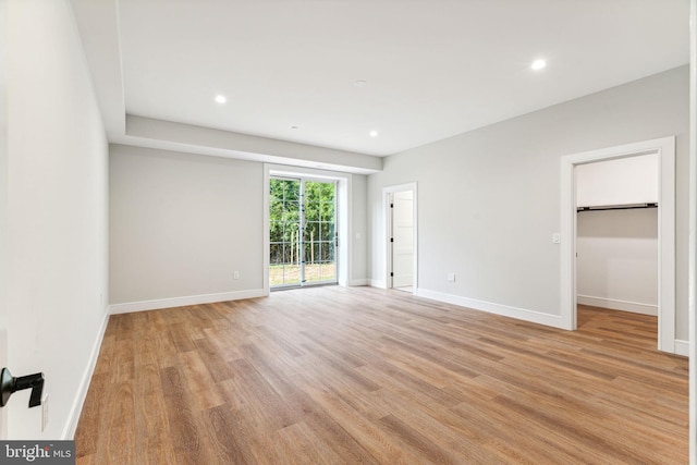 unfurnished bedroom with access to outside, baseboards, light wood-style flooring, and recessed lighting