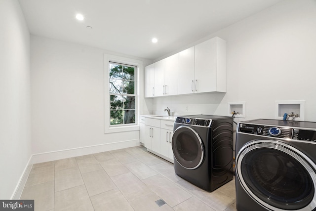 laundry room with cabinet space, baseboards, washer and clothes dryer, a sink, and recessed lighting