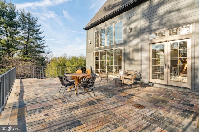 wooden deck featuring french doors and outdoor dining area