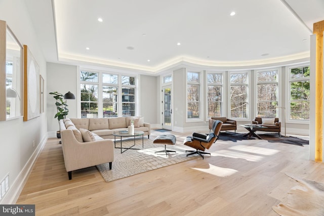 sunroom / solarium with a tray ceiling and visible vents