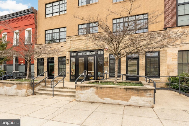 view of exterior entry featuring brick siding