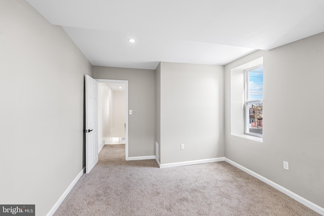 unfurnished bedroom with carpet, baseboards, and recessed lighting