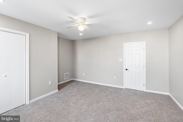 unfurnished bedroom featuring baseboards, visible vents, ceiling fan, and carpet flooring