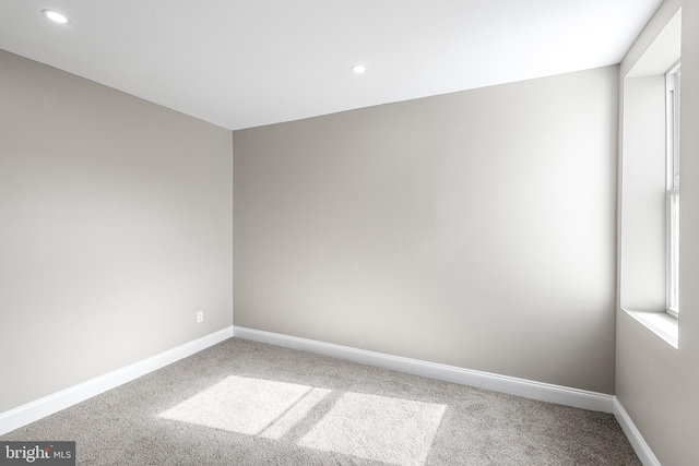 carpeted empty room featuring recessed lighting and baseboards