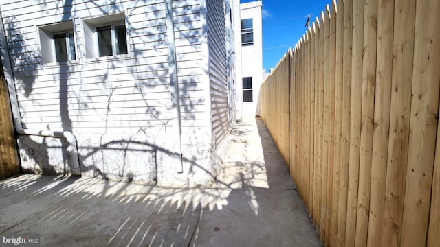 view of side of home with fence