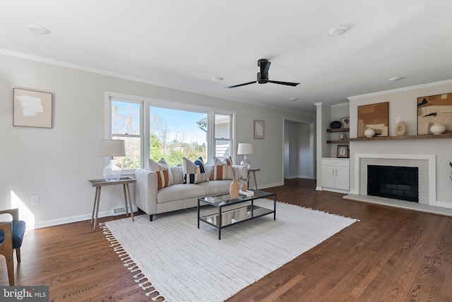 living area featuring ornamental molding, dark wood-style flooring, a fireplace with raised hearth, and baseboards