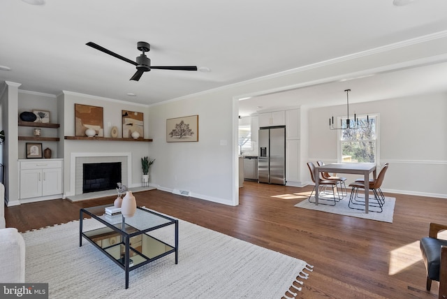 living room with baseboards, visible vents, a fireplace with raised hearth, dark wood-style floors, and crown molding