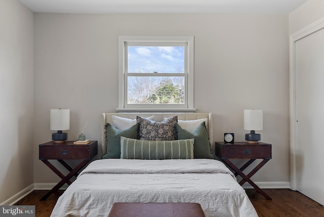 bedroom featuring dark wood finished floors and baseboards