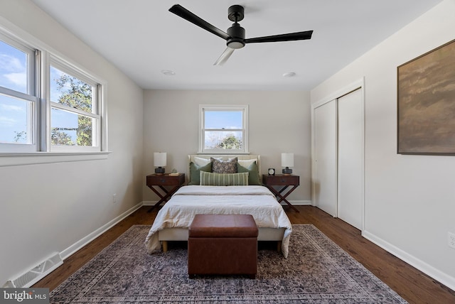 bedroom featuring baseboards, multiple windows, visible vents, and dark wood-style flooring