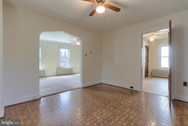 659 E Maple St, Annville, PA 17003 - empty room with radiator, ceiling fan, and a wealth of natural light