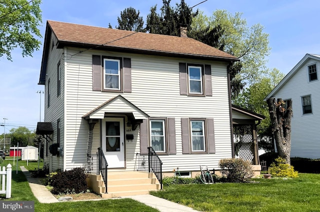 659 E Maple St, Annville, PA 17003 - traditional-style house featuring a shingled roof, a chimney, and a front lawn
