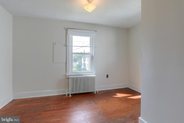 659 E Maple St, Annville, PA 17003 - spare room featuring baseboards, radiator heating unit, and hardwood / wood-style flooring