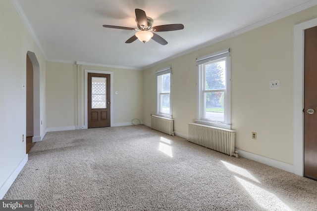 659 E Maple St, Annville, PA 17003 - carpeted spare room featuring crown molding, arched walkways, ceiling fan, and radiator