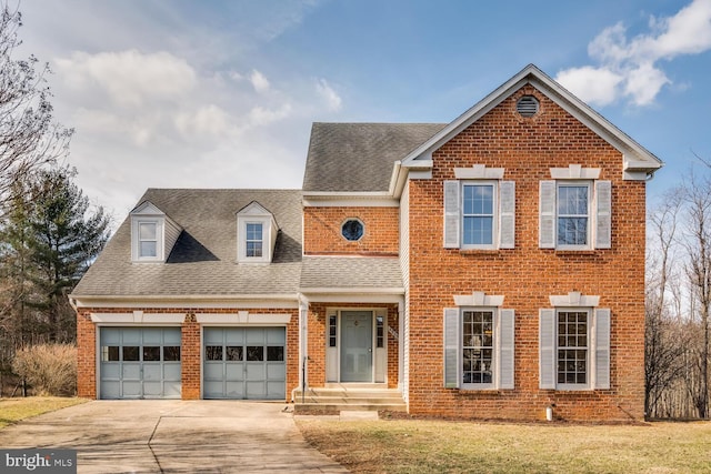 traditional-style home featuring concrete driveway, brick siding, and roof with shingles