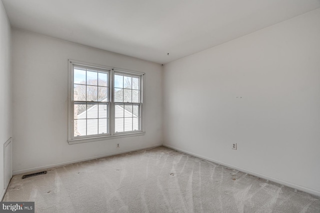 unfurnished room featuring carpet floors, baseboards, and visible vents