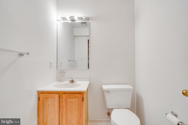 half bathroom with visible vents, vanity, and toilet