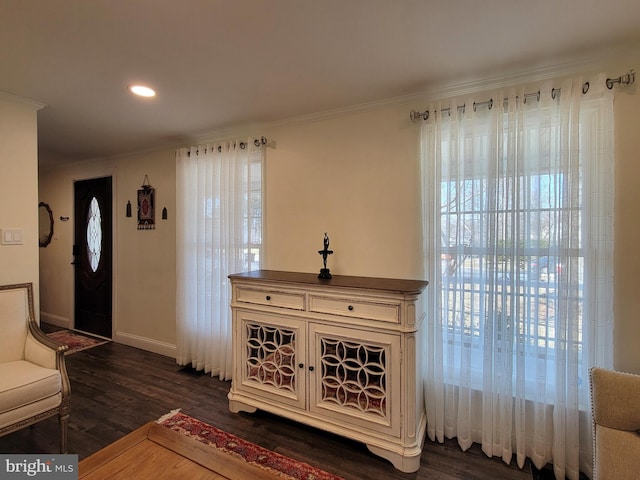 interior space featuring baseboards, dark wood-style flooring, recessed lighting, and crown molding