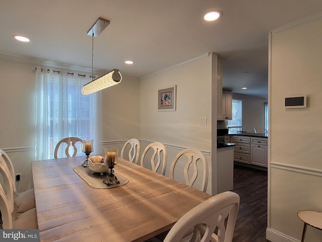 dining space featuring ornamental molding, dark wood-type flooring, and recessed lighting