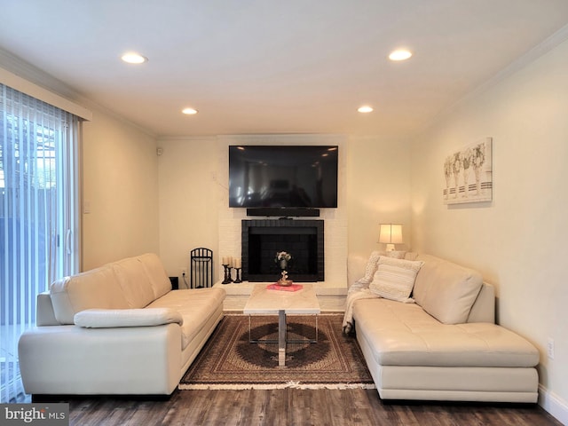 living area with recessed lighting, a fireplace, crown molding, and wood finished floors