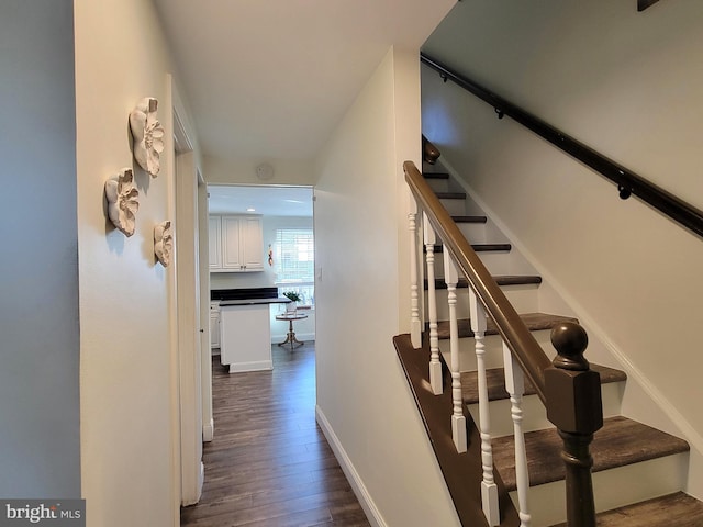 interior space featuring wood finished floors and baseboards