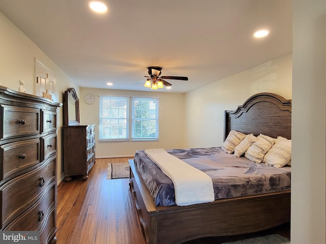 bedroom with hardwood / wood-style floors, a ceiling fan, and recessed lighting