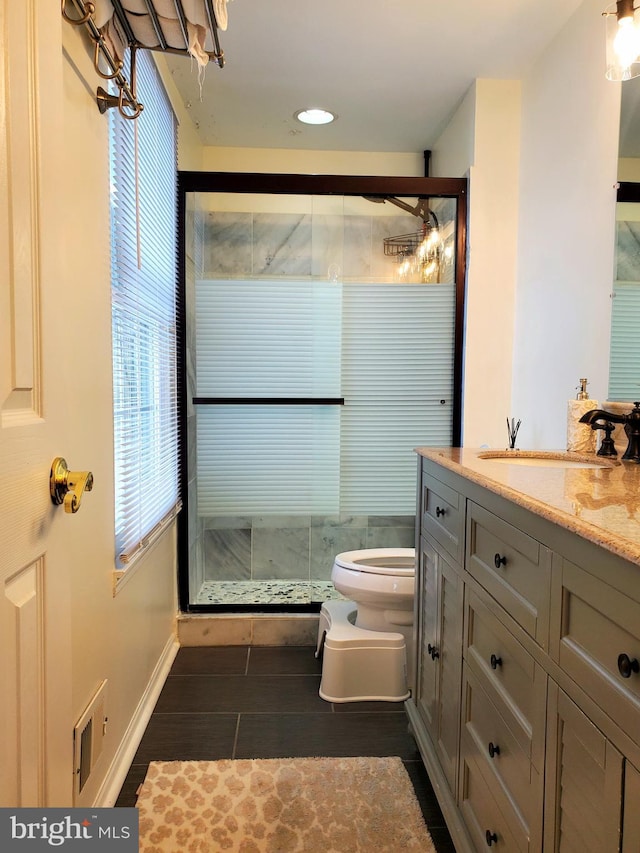 bathroom with wood finished floors, a shower stall, toilet, and vanity