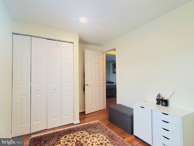 bedroom featuring light wood-style floors and a closet