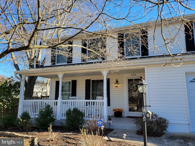 view of front of house featuring a porch and a garage