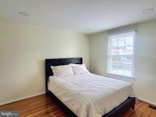 bedroom featuring baseboards and wood finished floors