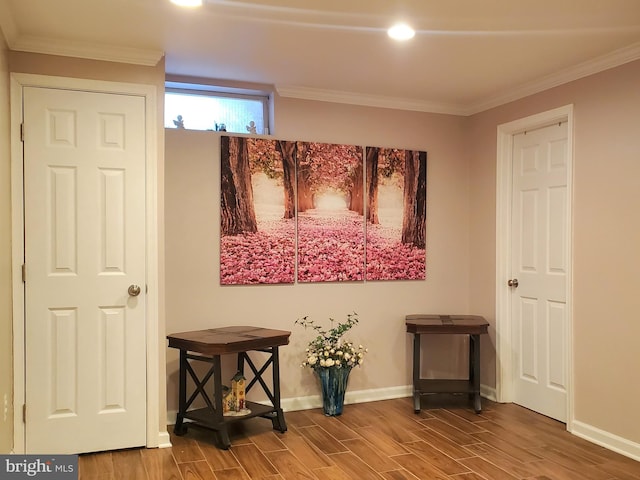 interior space featuring ornamental molding, wood finish floors, and baseboards