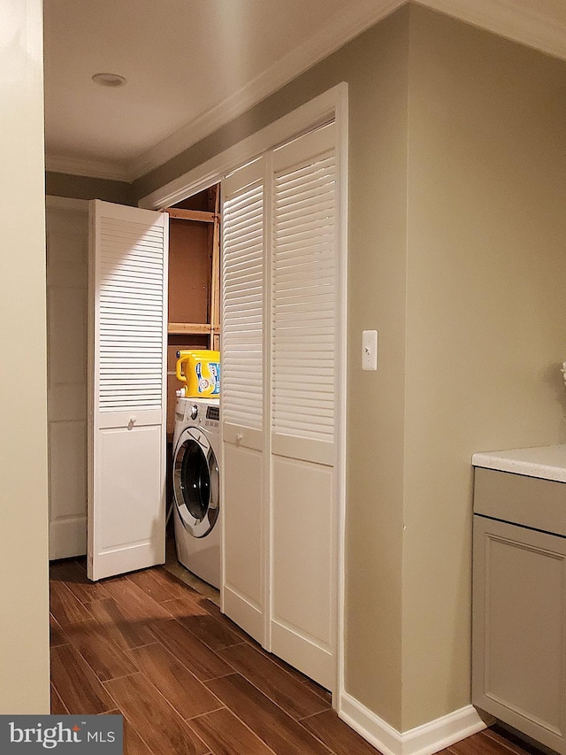 laundry room with laundry area, washer / clothes dryer, dark wood-type flooring, and baseboards