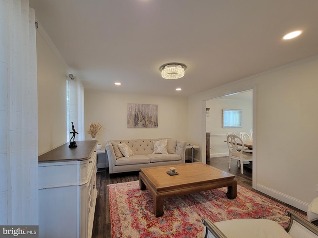 living area featuring baseboards, ornamental molding, dark wood-type flooring, and recessed lighting