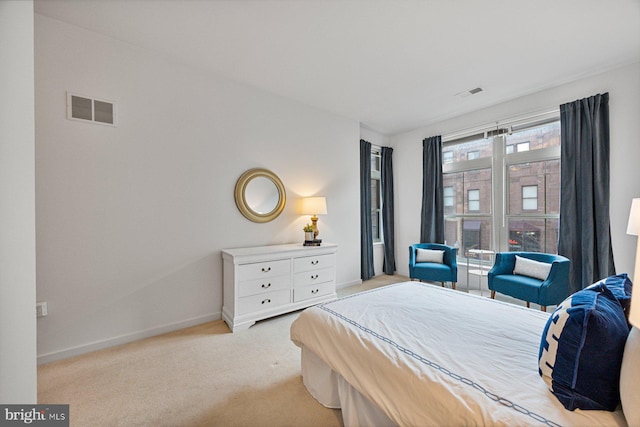 carpeted bedroom with baseboards and visible vents