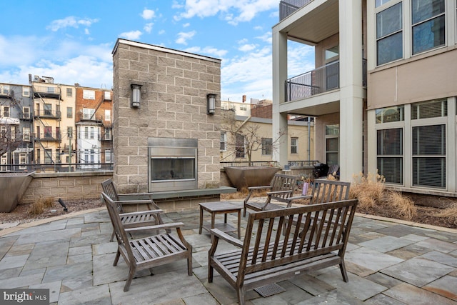 view of patio / terrace featuring an outdoor living space with a fireplace