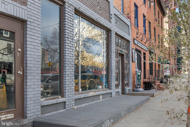 doorway to property featuring brick siding