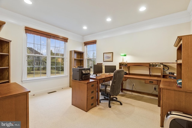 office space with visible vents, light colored carpet, a healthy amount of sunlight, and ornamental molding