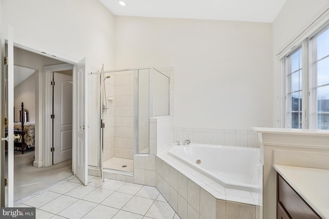 ensuite bathroom with vanity, a shower stall, ensuite bathroom, tile patterned floors, and a jetted tub