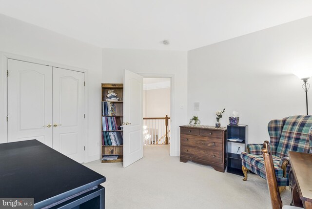 interior space with carpet flooring and an upstairs landing