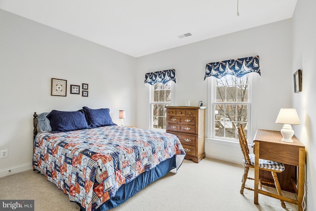 bedroom featuring visible vents, multiple windows, carpet, and baseboards