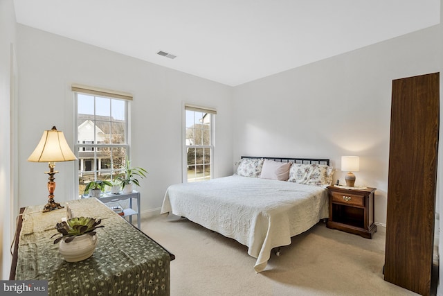 bedroom with visible vents, baseboards, and carpet floors