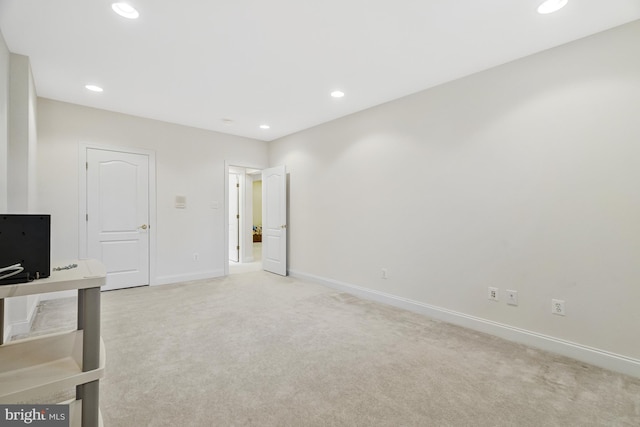 interior space featuring recessed lighting, baseboards, and light colored carpet