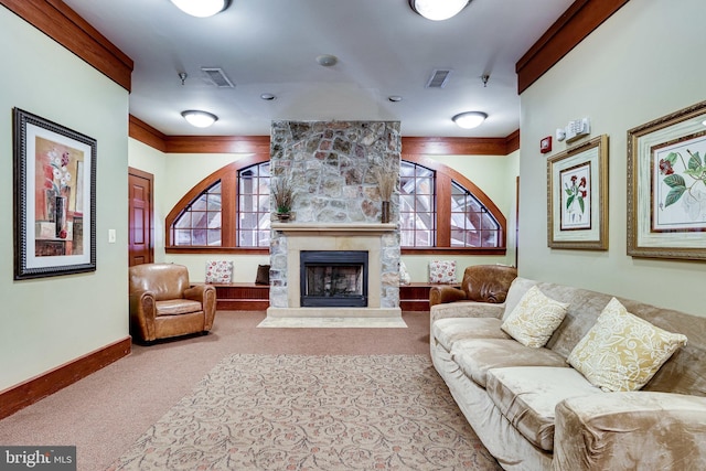 living room with visible vents, baseboards, a stone fireplace, and carpet