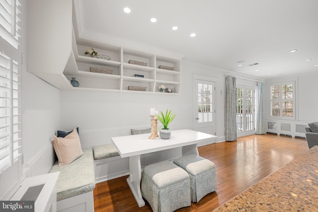 dining room featuring recessed lighting, crown molding, and wood finished floors